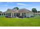 Spacious backyard featuring a patio, hot tub, and well-manicured lawn, perfect for outdoor entertaining at 483 Oakmont Dr., Myrtle Beach, SC 29579