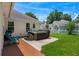 Relaxing backyard featuring a hot tub on a concrete patio and green lawn at 483 Oakmont Dr., Myrtle Beach, SC 29579