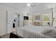 Inviting bedroom featuring large windows, a ceiling fan, and an ensuite bathroom with tiled shower at 483 Oakmont Dr., Myrtle Beach, SC 29579