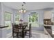 Bright dining area with tiled floors, a chandelier, and a view of the backyard at 483 Oakmont Dr., Myrtle Beach, SC 29579