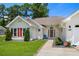 Close up of a well-maintained home with red shutters, a red door and a security system sign at 483 Oakmont Dr., Myrtle Beach, SC 29579