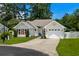 Charming single-story home featuring a manicured lawn and attached garage with a paved driveway at 483 Oakmont Dr., Myrtle Beach, SC 29579