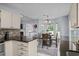 Open kitchen layout flowing to a dining area, granite counters, stainless appliances, and mosaic tile backsplash at 483 Oakmont Dr., Myrtle Beach, SC 29579