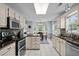 Charming kitchen with an island, stainless steel appliances, and a cozy dining area bathed in natural light at 483 Oakmont Dr., Myrtle Beach, SC 29579
