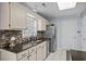 Bright kitchen boasts updated countertops, mosaic backsplash, stainless steel appliances, and ample cabinet space at 483 Oakmont Dr., Myrtle Beach, SC 29579