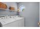 Functional laundry room with modern appliances, shelving for storage, and natural light at 483 Oakmont Dr., Myrtle Beach, SC 29579