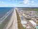 Sweeping aerial view of a coastal community with a pristine beach and beautiful ocean views at 5000 N Ocean Blvd. # E-2, North Myrtle Beach, SC 29582