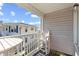 Covered balcony with a white wooden chair and table and a view of a neighboring building at 5000 N Ocean Blvd. # E-2, North Myrtle Beach, SC 29582