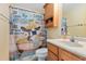 Bathroom featuring a vanity with storage, a toilet, and a shower/tub combination with a novelty shower curtain at 5000 N Ocean Blvd. # E-2, North Myrtle Beach, SC 29582
