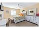 Bright bedroom with pineapple themed bedspread, white furniture, and a ceiling fan at 5000 N Ocean Blvd. # E-2, North Myrtle Beach, SC 29582