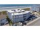 View of multi-story condo building located close to the beach with compact parking and outdoor showers at 5000 N Ocean Blvd. # E-2, North Myrtle Beach, SC 29582
