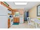 Well-lit kitchen featuring white appliances and wood cabinets near a breakfast nook at 5000 N Ocean Blvd. # E-2, North Myrtle Beach, SC 29582