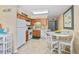 Cozy kitchen featuring tile floors, wooden cabinetry and a white dining table with seating for four at 5000 N Ocean Blvd. # E-2, North Myrtle Beach, SC 29582