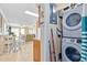 A laundry closet next to the dining area featuring a stackable washer and dryer at 5000 N Ocean Blvd. # E-2, North Myrtle Beach, SC 29582