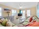 Comfortable living room with an L-shaped green sofa, neutral carpet, and coastal-themed decor at 5000 N Ocean Blvd. # E-2, North Myrtle Beach, SC 29582