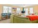 Bright and airy living room features a comfortable green couch, pelican lamp and balcony access at 5000 N Ocean Blvd. # E-2, North Myrtle Beach, SC 29582
