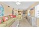 Bright living room leading into the kitchen and dining area, with beachy decor and comfortable seating at 5000 N Ocean Blvd. # E-2, North Myrtle Beach, SC 29582