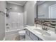 Bathroom featuring a tub, toilet, vanity with a modern faucet, and a framed mirror at 505 41St Ave. S, North Myrtle Beach, SC 29582
