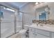 Well-lit bathroom featuring a glass-enclosed shower, toilet, and a vanity with mosaic backsplash at 505 41St Ave. S, North Myrtle Beach, SC 29582