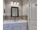 Bright bathroom featuring a white vanity, stylish mosaic backsplash, framed mirror and modern lighting fixture at 505 41St Ave. S, North Myrtle Beach, SC 29582