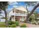 Charming coastal home with double balconies, ceiling fans, and well-maintained landscaping, inviting outdoor relaxation at 505 41St Ave. S, North Myrtle Beach, SC 29582