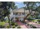 Charming two-story home features a spacious porch, lovely landscaping, and a brick driveway leading to ample parking at 505 41St Ave. S, North Myrtle Beach, SC 29582