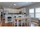 Bright, open kitchen boasts white cabinets, stainless steel appliances, and barstool seating at the counter at 505 41St Ave. S, North Myrtle Beach, SC 29582