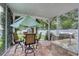 Covered patio with outdoor dining area, grill, and landscaped yard at 505 41St Ave. S, North Myrtle Beach, SC 29582