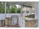 Outdoor kitchen with stainless steel grill, granite countertops, and built-in sink at 505 41St Ave. S, North Myrtle Beach, SC 29582