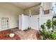Enclosed outdoor shower area with white privacy walls and brick pathway, ideal for rinsing off after outdoor activities at 505 41St Ave. S, North Myrtle Beach, SC 29582