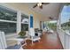 Inviting porch with classic white railings and comfortable seating offers a relaxing outdoor space with ceiling fans at 505 41St Ave. S, North Myrtle Beach, SC 29582