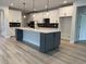 Modern kitchen with an island, white cabinets, and stainless steel appliances at 528 Oak Landing Dr., Myrtle Beach, SC 29588