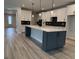 Modern kitchen with an island, white cabinets, and stainless steel appliances at 528 Oak Landing Dr., Myrtle Beach, SC 29588