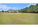 Spacious yard with large open area and trees around the perimeter at 580 Circle M Rd., Longs, SC 29568