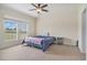 Bedroom with neutral carpet, ceiling fan, and a large window overlooking the property at 580 Circle M Rd., Longs, SC 29568