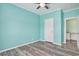 Bedroom featuring laminate flooring, a ceiling fan, and a doorway to an office at 580 Circle M Rd., Longs, SC 29568