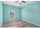 Bedroom featuring laminate flooring, a ceiling fan, and a large window at 580 Circle M Rd., Longs, SC 29568
