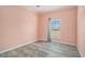 Bright bedroom features wood-look flooring and a large window for natural light at 580 Circle M Rd., Longs, SC 29568