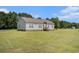 Well-maintained single-story home with vinyl siding, a brick foundation, and a spacious, mowed lawn at 580 Circle M Rd., Longs, SC 29568