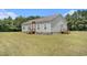 Well-maintained single-story home with vinyl siding, a brick foundation, and a spacious, mowed lawn at 580 Circle M Rd., Longs, SC 29568