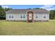 Charming single-story home with vinyl siding, a brick foundation, and well-manicured lawn at 580 Circle M Rd., Longs, SC 29568