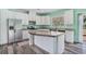 Bright kitchen with stainless steel appliances, white cabinets, and a large island featuring stone countertop at 580 Circle M Rd., Longs, SC 29568