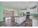 Open kitchen features white cabinets, stainless steel appliances, and a center island with stone countertop at 580 Circle M Rd., Longs, SC 29568