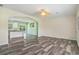 Open concept living area with hardwood floors, ceiling fan, and a view of the kitchen at 580 Circle M Rd., Longs, SC 29568