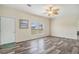 Bright living room featuring wood-look floors, a decorative fan, and natural light from the windows at 580 Circle M Rd., Longs, SC 29568