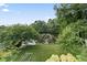 Lush backyard with pond views, mature trees, and ample space for recreation at 5867 Rosewood Dr., Myrtle Beach, SC 29588