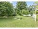 Lush backyard features a pond, mature trees, a well-manicured lawn, and a garden bed for outdoor serenity at 5867 Rosewood Dr., Myrtle Beach, SC 29588