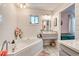 Bright bathroom features a soaking tub with white subway tile, vanity, and neutral tones throughout at 5867 Rosewood Dr., Myrtle Beach, SC 29588