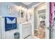 Bathroom featuring a vanity, mirror, and wood-look tile floors, creating a clean and bright space at 5867 Rosewood Dr., Myrtle Beach, SC 29588