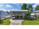 Charming two-story home featuring a covered porch, driveway parking, and a beautifully landscaped front yard at 5867 Rosewood Dr., Myrtle Beach, SC 29588